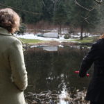 two women overlooking a creek on fraser valley british columbia